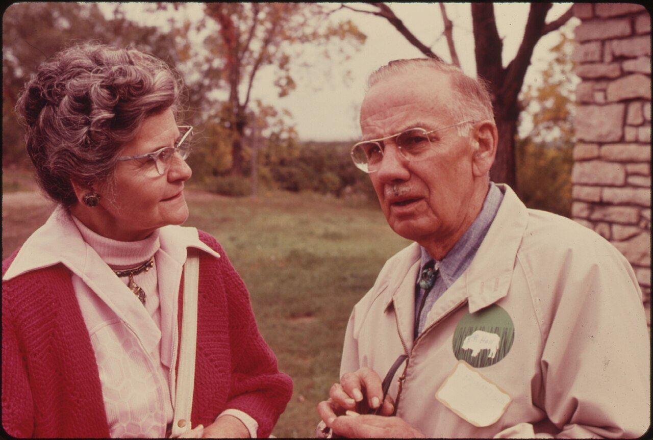 DR. E. RAYMOND HALL, THE FOUNDER OF THE MOVEMENT FOR A TALLGRASS PRAIRIE NATIONAL PARK, TALKS TO A WOMAN AT THE... - NARA - 557143, illustrative activity photo