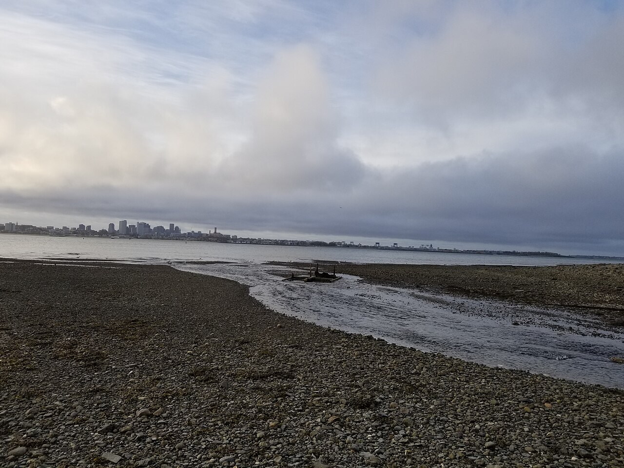 Seawater entering the lagoon on Thompson Island with Boston Harbor and South Boston visible in the background in Massachusetts MA, illustrative activity photo